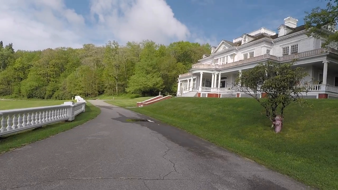 Large White Mansion With Greenery And Driveway