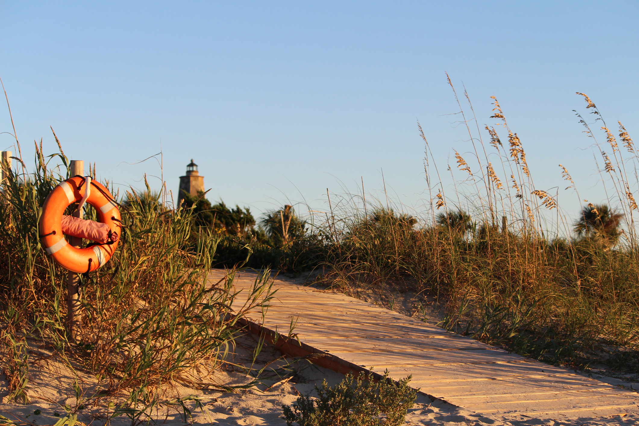Old Baldy Lighthouse peaking over the Sand Dune at Sunset on Bald Head Island