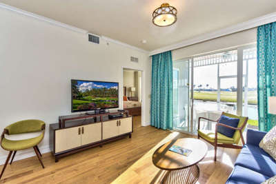 Living Room with Brand New Furniture and Flat Screen HDTV; Entrance to Lanai Area with Golf and Lake Views;
