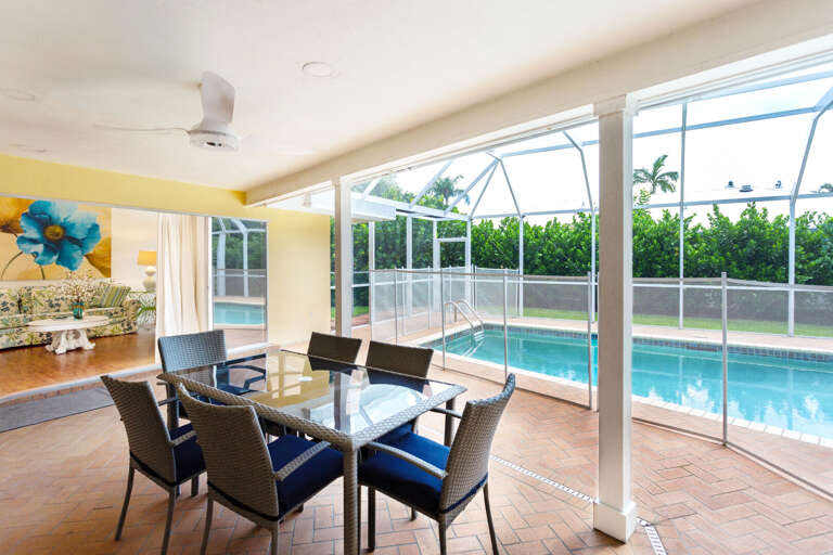 Outdoor sitting and dining area.  Home comes with removable child's safety fence around the pool