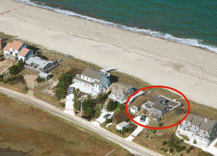Aerial view of cottage and beach