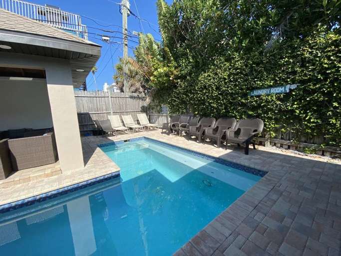 Pool Area with outdoor seating, TV, Microwave and mini fridge.