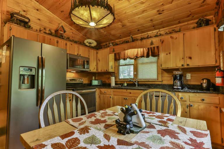 The country kitchen has a modern look with stainless steel appliances and granite countertops.