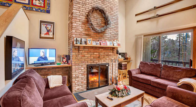 Living room with wood burning fireplace to keep you warm even on the coldest days