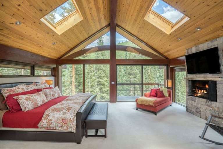 Master Bedroom has Floor to Ceiling Windows and a King Bed