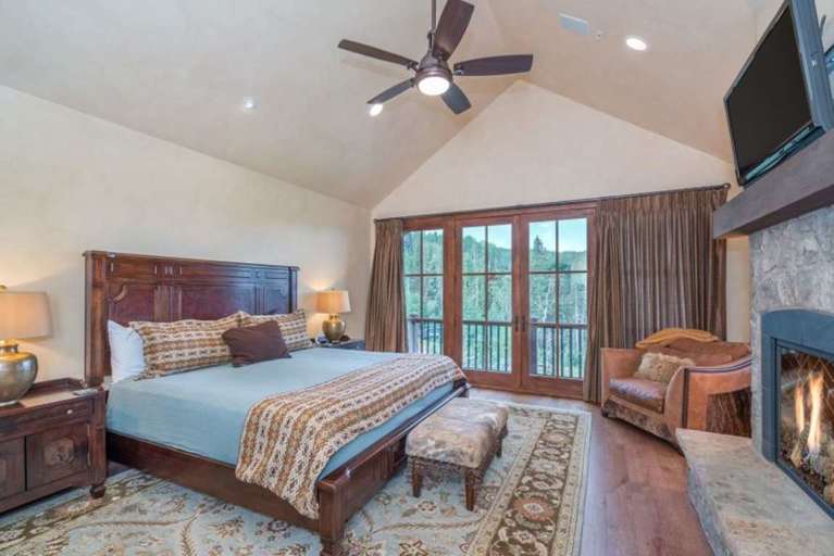 Master Bedroom Features a King Bed, Fireplace, and Flat-Screen TV