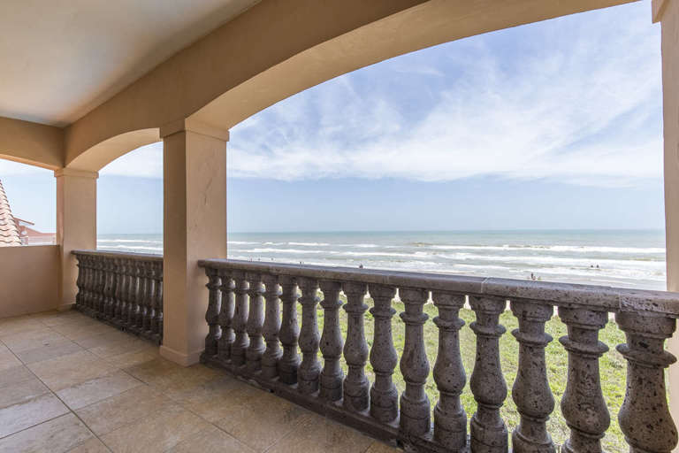 Large second floor balcony overlooking the pool and beach.