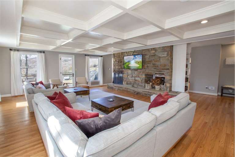 Great Room with Coffered Ceiling, Huge Stone Fireplace, and HD Smart TV