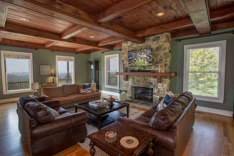 Living Room at The Retreat with Huge View Windows, Stone Fireplace, and HD Smart TV