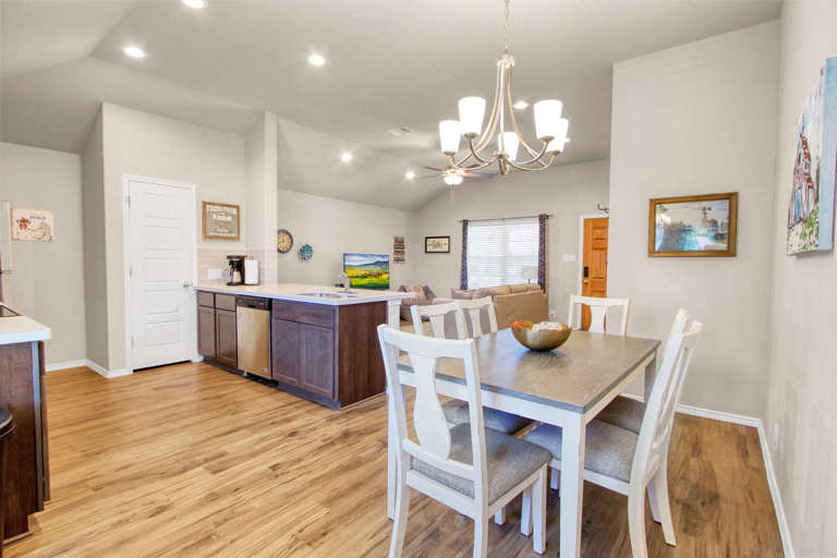 The house features an open floor plan with connected living, dining and kitchen.