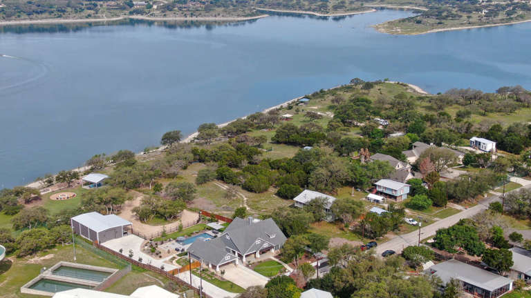Aerial view showing Canyon Lake in the backyard of the home.
