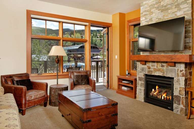 Gathering area with Gas Fireplace, Large Screen TV, and access to outdoor patio
