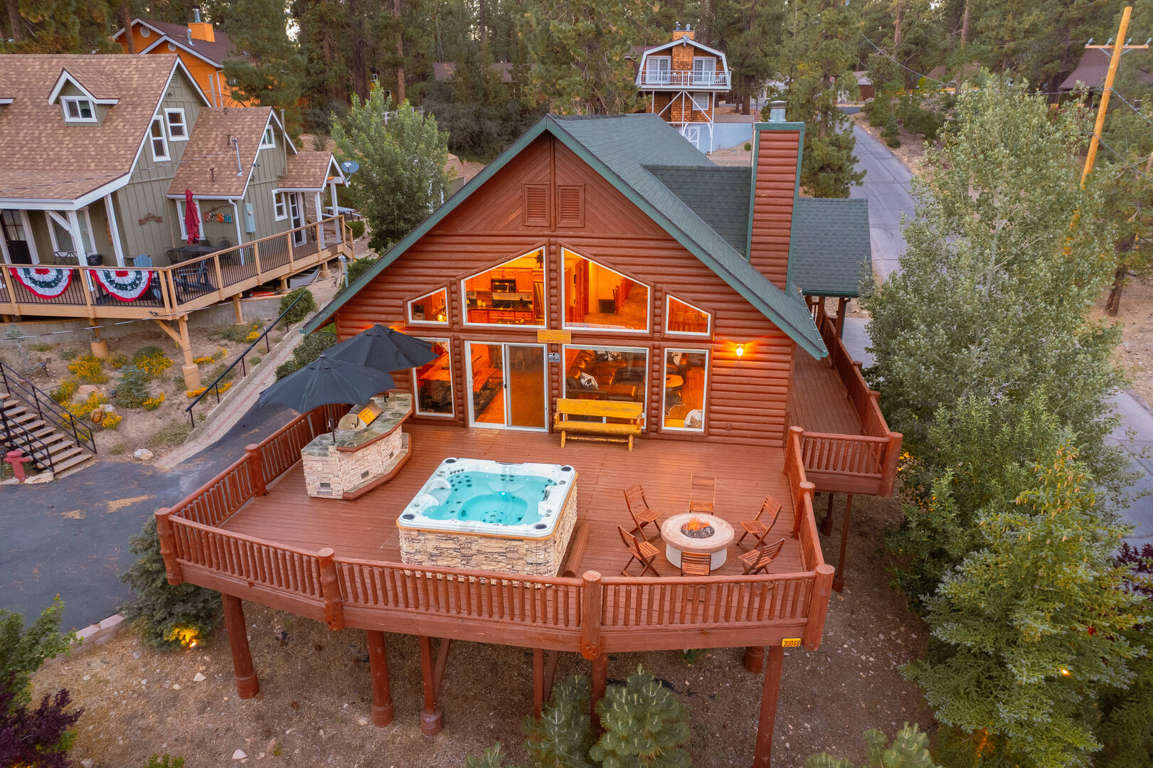AERIAL VIEW OF THE BACK OF THE HOUSE/BACK DECK.
INCLUDES JACUZZI TUB, FIRE PIT, AND ISLAND BBQ!