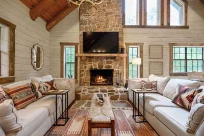 Cozy living area with real wood fireplace and 65" smart TV with DirecTV