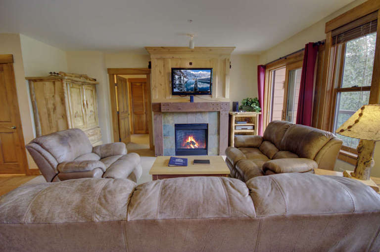 The living room has a TV and a fireplace for cold days