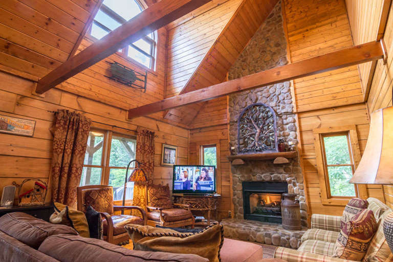 Living room with couches and chairs and gas log fireplace