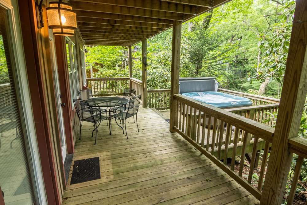 Deck with table, chairs and a hot tub