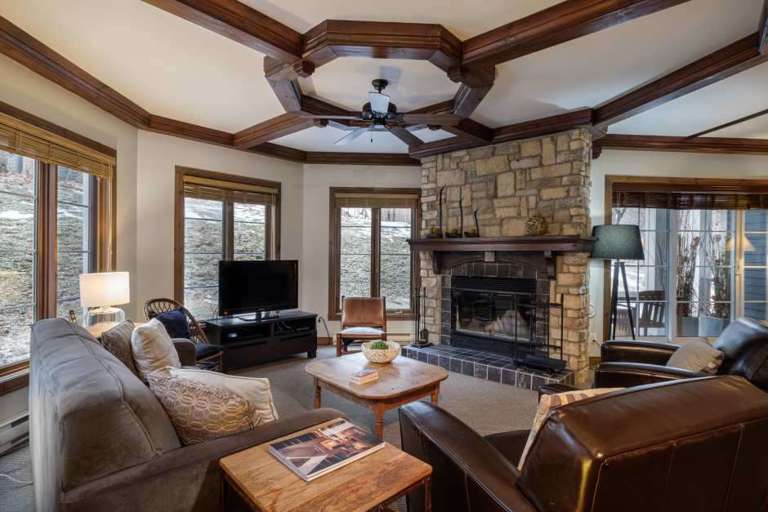 The Living Area Featuring a Large Stone Fireplace and Flat Screen TV