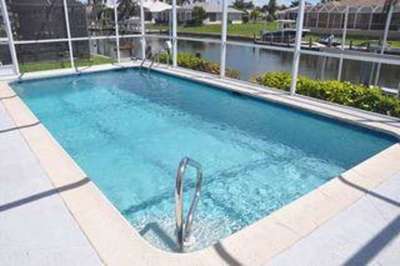 Marco Island property on canal with large pool a boat dock and lift 3 bedrooms